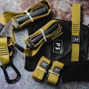 Army green body weight suspension trainer with black handles and straps, designed for home, outdoor, and travel workouts.